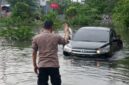 Mobil dinas Kepala Dinas Perpusip Gresik terjebak banjir setinggi 1,5 meter di Driyorejo akibat drainase tersumbat.